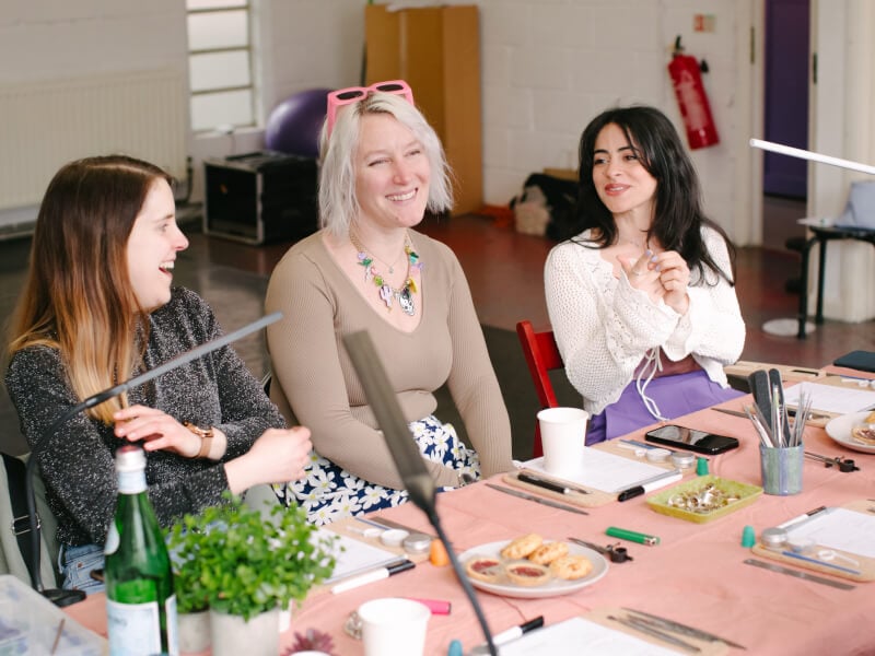 Women smiling at a jewellery making class